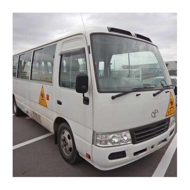 Toyota Coaster bus with strong body design and advanced safety features Toyota Coaster vehicle for public transport and private hire services Toyota Coaster high roof bus for maximum passenger capacity Toyota Coaster minibus with manual and automatic transmission options - Image 1